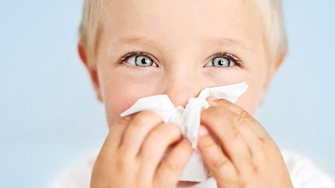 boy wiping nose with wipe